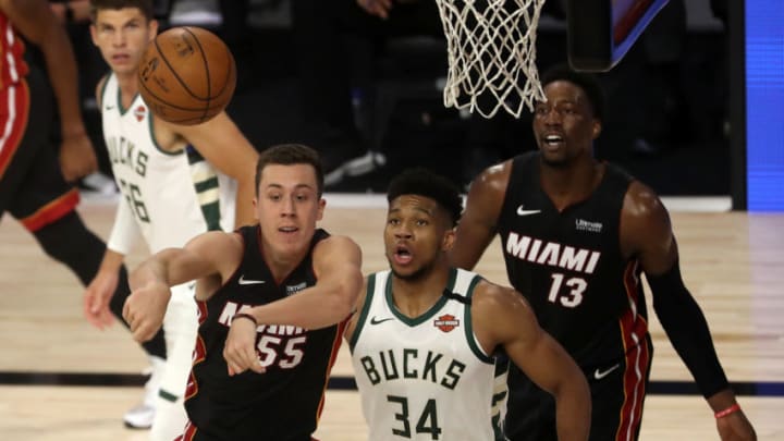 Giannis Antetokounmpo #34 of the Milwaukee Bucks and Duncan Robinson #55 of the Miami Heat and Bam Adebayo #13 of the Miami Heat (Photo by Mike Ehrmann/Getty Images)