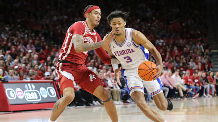 Feb 18, 2023; Fayetteville, Arkansas, USA; Florida Gators forward Alex Fudge (3) drives against Arkansas Razorbacks forward Jalen Graham (11) in the first half at Bud Walton Arena. Mandatory Credit: Nelson Chenault-USA TODAY Sports