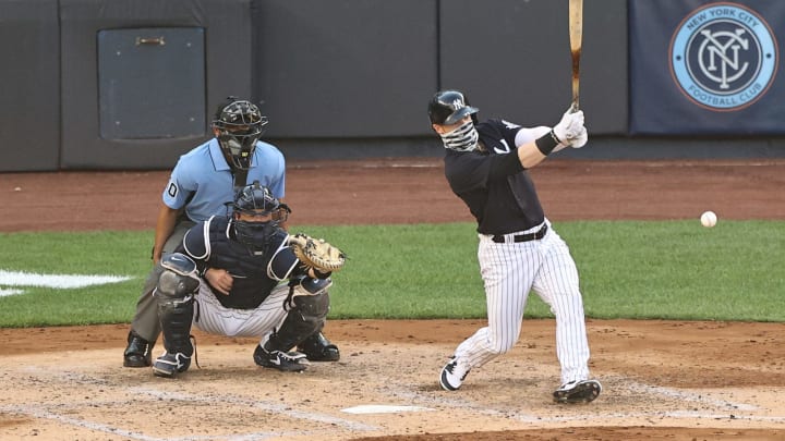 NEW YORK, NEW YORK – JULY 14: Clint Frazier #77 of the New York Yankees takes his at bat as Kyle Higashioka #66 of the New York Yankees catches during an intrasquad game of summer workouts at Yankee Stadium on July 14, 2020 in the Bronx borough of New York City.Both players wore face coverings. (Photo by Elsa/Getty Images)