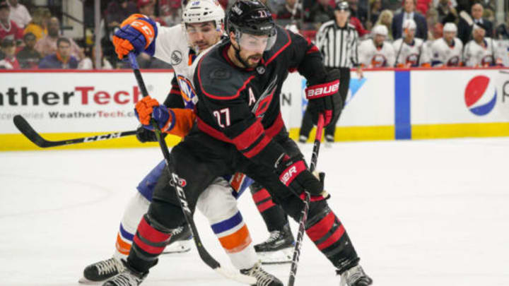 RALEIGH, NC – MAY 03: Carolina Hurricanes defenseman Justin Faulk (27) steals a puck from New York Islanders left wing Michael Dal Colle (28) during a game between the Carolina Hurricanes and the New York Islanders on March 3, 2019 at the PNC Arena in Raleigh, NC. (Photo by Greg Thompson/Icon Sportswire via Getty Images)