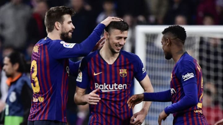 (L-R) Barcelona's Spanish defender Gerard Pique, Barcelona's French defender Clement Lenglet and Barcelona's French forward Ousmane Dembele celebrate at the end of the Spanish league football match between Real Madrid CF and FC Barcelona at the Santiago Bernabeu stadium in Madrid on March 2, 2019. (Photo by JAVIER SORIANO / AFP) (Photo credit should read JAVIER SORIANO/AFP/Getty Images)