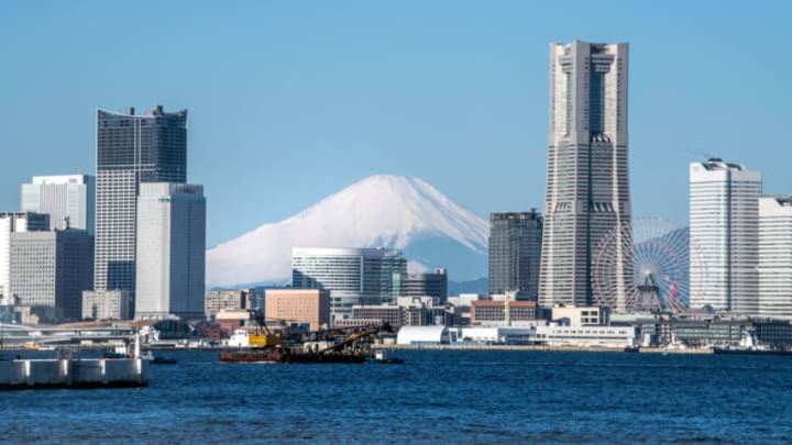YOKOHAMA, JAPAN - FEBRUARY 11: Mount Fuji is seen behind the Yokohama skyline on February 11, 2020 in Yokohama, Japan. (Photo by Carl Court/Getty Images)
