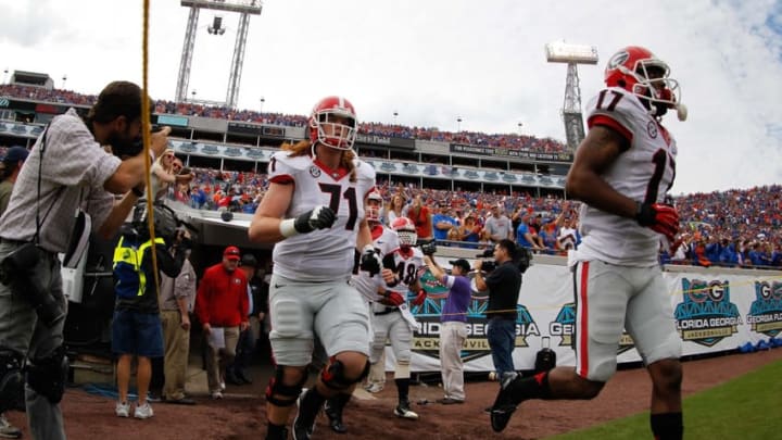 Nov 2, 2013; Jacksonville, FL, USA; Georgia Bulldogs offensive tackle John Theus (71) and teammates runs out of the tunnel prior to the game against the Florida Gators at EverBank Field. Mandatory Credit: Kim Klement-USA TODAY Sports