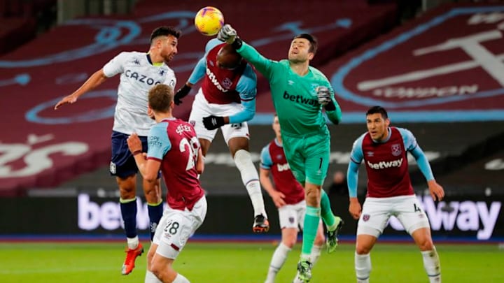 West Ham keeper Lukasz Fabianski punches away from Aston Villa attackers. (Photo by FRANK AUGSTEIN/POOL/AFP via Getty Images)