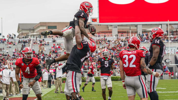 Apr 16, 2022; Athens, Georgia, USA; Georgia Bulldogs running back Kendall Milton (2) gets lifter by offensive lineman Devin Willock (77) after a touchdown during the Georgia Bulldogs Spring Game at Sanford Stadium. Mandatory Credit: Dale Zanine-USA TODAY Sports