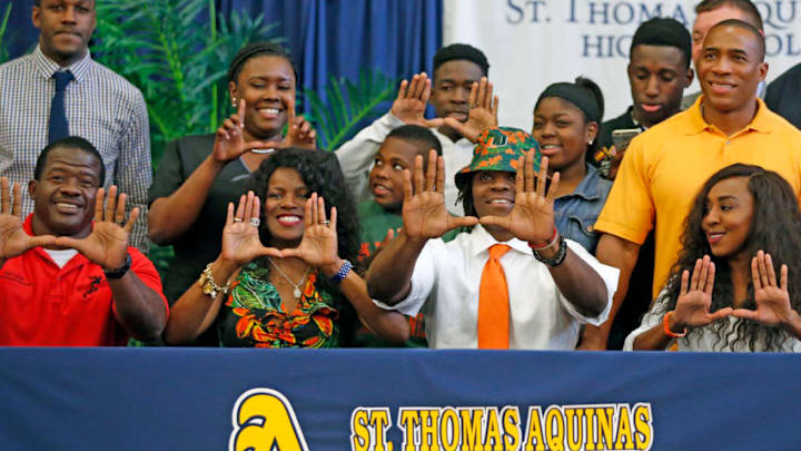 St. Thomas Aquinas' Michael Irvin Jr. makes the 'U' sign with his family as he signs with the University of Miami on National Signing Day at Saint Thomas Aquinas High School in Fort Lauderdale, Fla., on Wednesday, Feb. 3, 2016. (Charles Trainor, Jr./Miami Herald/TNS via Getty Images)