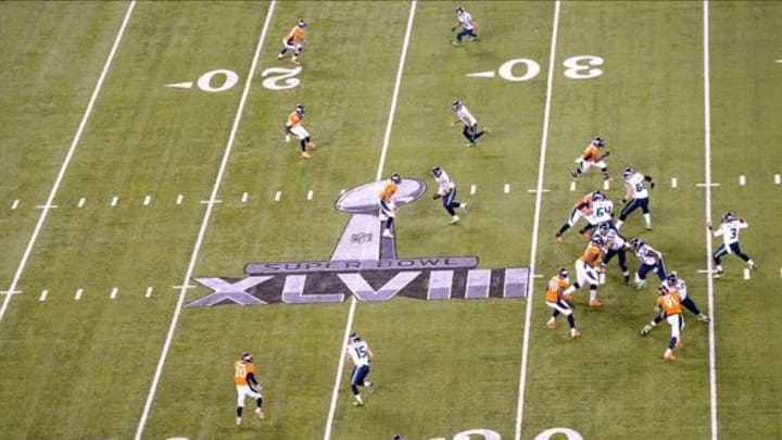 Feb 2, 2014; East Rutherford, NJ, USA; General view of the Super Bowl XLVIII logo as Seattle Seahawks quarterback throws the ball against the Denver Broncos at MetLife Stadium. The Seahawks defeated the Broncos 43-8. Mandatory Credit: Kirby Lee-USA TODAY Sports