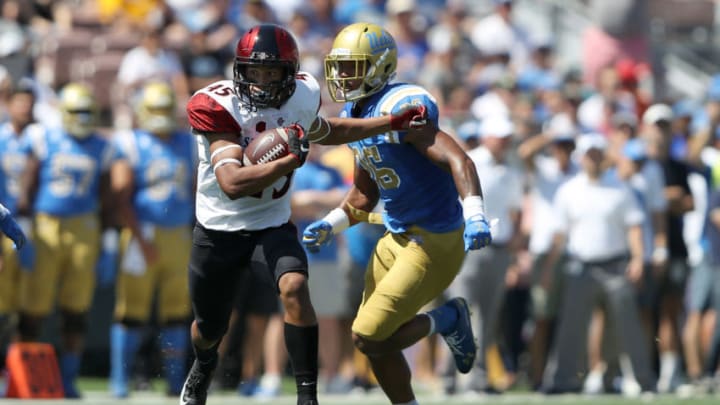LOS ANGELES, CALIFORNIA - SEPTEMBER 07: Jesse Matthews #45 of the San Diego State Aztecs eludes Leni Toailoa #26 of the UCLA Bruins on a pass play during the first half of a game on September 07, 2019 in Los Angeles, California. (Photo by Sean M. Haffey/Getty Images)