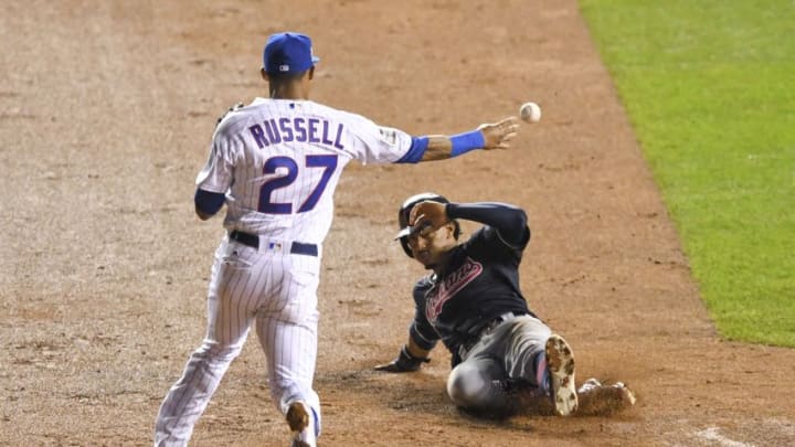 Chicago Cubs shortstop Addison Russell (27) completes a double play against Cleveland Indians counterpart shortstop Francisco Lindor (right) during the third inning in game four of the 2016 World Series at Wrigley Field. Mandatory Credit: Dennis Wierzbicki-USA TODAY Sports