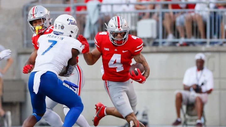 Ohio State Buckeyes wide receiver Julian Fleming (4) runs toward Tulsa Golden Hurricane safety TieNeal Martin (7) after making a catch during the third quarter of the NCAA football game at Ohio Stadium in Columbus on Saturday, Sept. 18, 2021.Tulsa At Ohio State Football