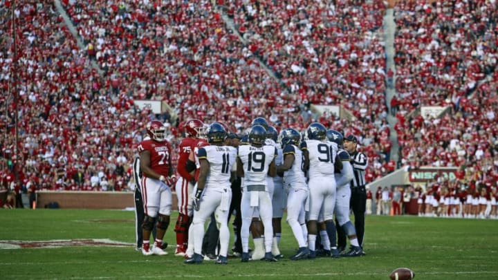 NORMAN, OK - NOVEMBER 25: The Oklahoma Sooners and West Virginia Mountaineers exchange words after a play at Gaylord Family Oklahoma Memorial Stadium on November 25, 2017 in Norman, Oklahoma. Oklahoma defeated West Virginia 59-31. (Photo by Brett Deering/Getty Images)