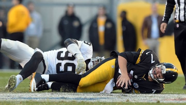 Nov 8, 2015; Pittsburgh, PA, USA; Pittsburgh Steelers quarterback Ben Roethlisberger (7) suffers an injury after a sack by Oaklanld Raiders defensive end Aldon Smith (99) in the fourth quarter in a NFL football game at Heinz Field. Mandatory Credit: Kirby Lee-USA TODAY Sports