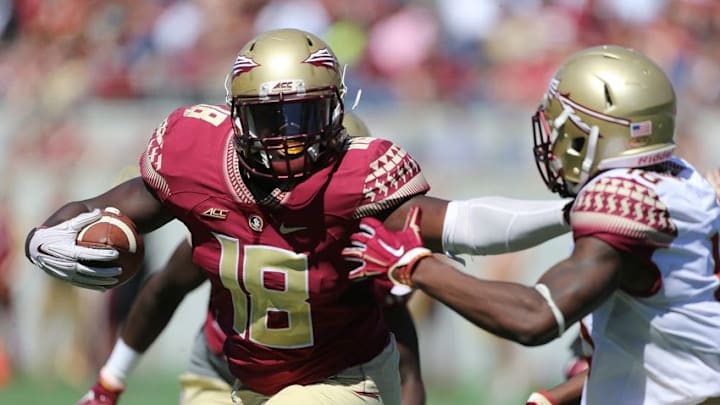 Apr 9, 2016; Orlando, FL, USA; Florida State Seminoles linebacker Ro'Derrick Hoskins (18) stiff arms Florida State Seminoles wide receiver Auden Tate (18) after an interception during the Florida State spring game at the Citrus Bowl. Mandatory Credit: Logan Bowles-USA TODAY Sports