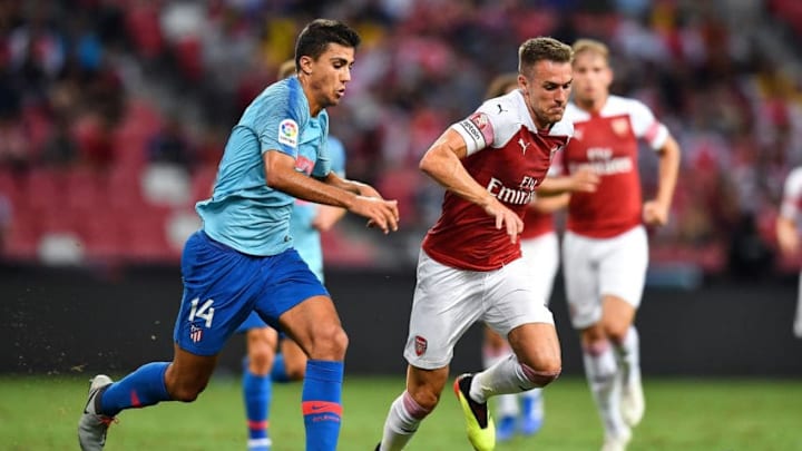 SINGAPORE - JULY 26: Rodri #14 of Atletico Madrid and Aaron Ramsey #8 of Arsenal compete for the ball during the International Champions Cup 2018 match between Club Atletico de Madrid and Arsenal at the National Stadium on July 26, 2018 in Singapore. (Photo by Thananuwat Srirasant/Getty Images for ICC)