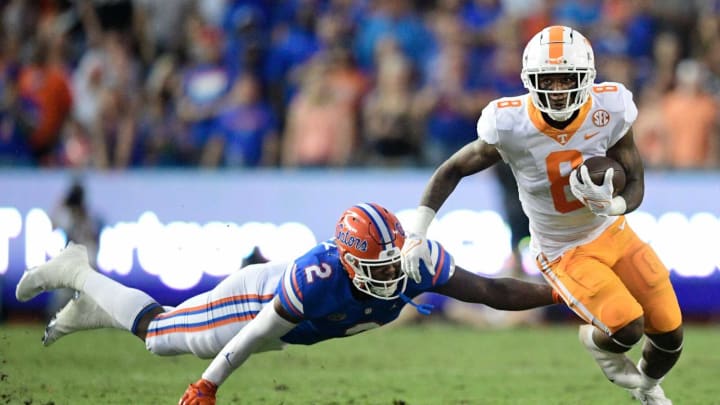 Tennessee running back Tiyon Evans (8) runs the ball as Florida linebacker Amari Burney (2) attempts to tackle him during the first quarter of an NCAA football game against Florida at Ben Hill Griffin Stadium in Gainesville, Florida on Saturday, Sept. 25, 2021.Tennflorida0925 0704