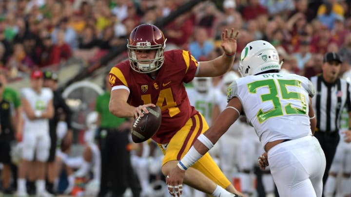 Nov 5, 2016; Los Angeles, CA, USA; Southern California Trojans quarterback Sam Darnold (14) is pressured by Oregon Ducks linebacker Troy Dye (35) during a NCAA football game at Los Angeles Memorial Coliseum. Mandatory Credit: Kirby Lee-USA TODAY Sports