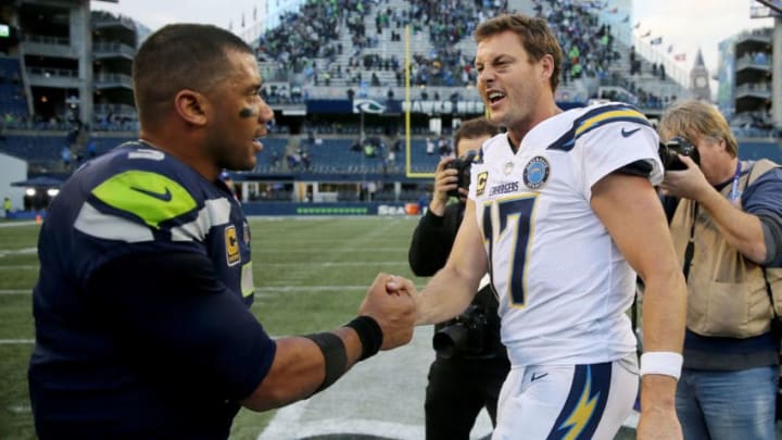 SEATTLE, WASHINGTON - NOVEMBER 04: Russell Wilson #3 of the Seattle Seahawks and Philip Rivers #17 of the Los Angeles Chargers meet after the Chargers beat the Seahawks 25-17 at CenturyLink Field on November 04, 2018 in Seattle, Washington. (Photo by Abbie Parr/Getty Images)