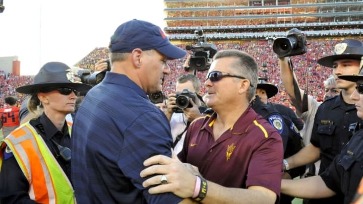 Nov 28, 2014; Tucson, AZ, USA; Arizona Wildcats head coach Rich Rodriguez and Arizona State Sun Devils head coach Todd Graham shake hands after the fourth quarter of the territorial cup at Arizona Stadium. Arizona won 42-35. Mandatory Credit: Casey Sapio-USA TODAY Sports