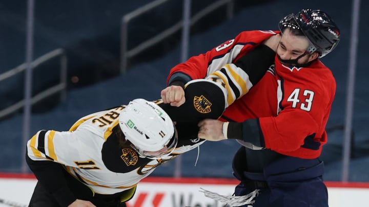 WASHINGTON, DC – FEBRUARY 01: Tom Wilson #43 of the Washington Capitals and Trent Frederic #11 of the Boston Bruins fight during the third period at Capital One Arena on February 01, 2021 in Washington, DC. (Photo by Patrick Smith/Getty Images)