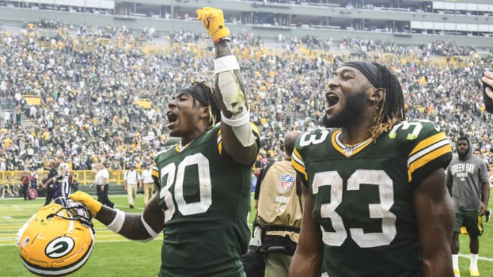 Sep 15, 2019; Green Bay, WI, USA; Green Bay Packers running back Jamaal Williams (30) and running back Aaron Jones (33) react after the Packers beat the Minnesota Vikings at Lambeau Field. Mandatory Credit: Benny Sieu-USA TODAY Sports