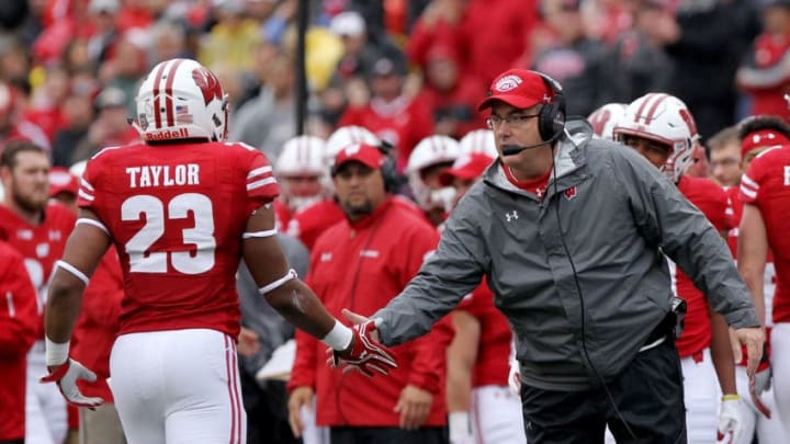 MADISON, WI - OCTOBER 14: Head coach Paul Chryst of the Wisconsin Badgers congratulates Jonathan Taylor