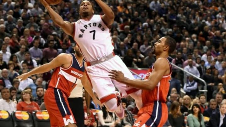 Jan 26, 2016; Toronto, Ontario, CAN; Toronto Raptors guard Kyle Lowry (7) drives to the basket and is fouled by Washington Wizards guard Ramon Sessions (7) in the fourth quarter of the Raptors 106-89 victory at Air Canada Centre. Mandatory Credit: Dan Hamilton-USA TODAY Sports