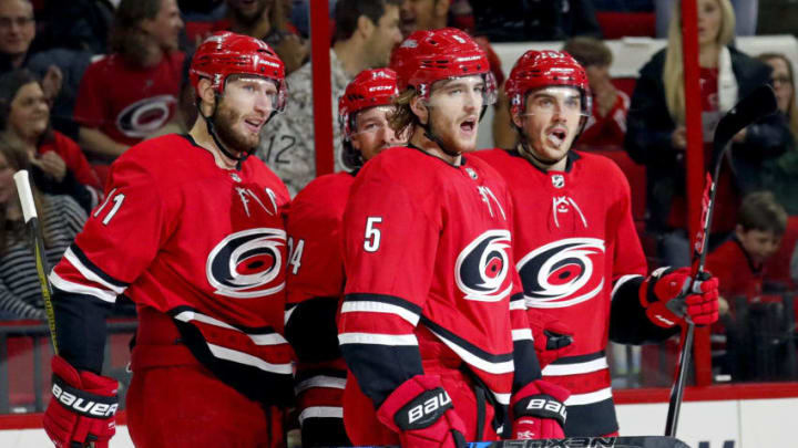 The Carolina Hurricanes' Noah Hanifin (5) celebrates his goal with teammates Jordan Staal (11) and Trevor van Riemsdyk (57) after he scored during the first period against the Tampa Bay Lightning at PNC Arena in Raleigh, N.C., on Saturday, April 7, 2018. (Chris Seward/Raleigh News & Observer/TNS via Getty Images)
