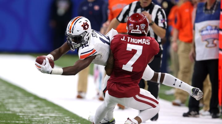 Jan 2, 2017; New Orleans , LA, USA; Auburn Tigers wide receiver Eli Stove (12) is tackled near the sideline by Oklahoma Sooners cornerback Jordan Thomas (7) after making a catch in the first quarter at the Mercedes-Benz Superdome. Mandatory Credit: Chuck Cook-USA TODAY Sports