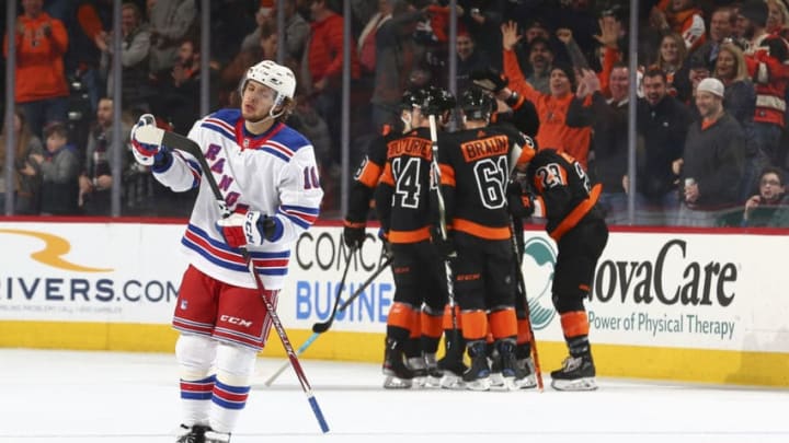 PHILADELPHIA, PA - FEBRUARY 28: Artemi Panarin #10 of the New York Rangers reacts as Sean Couturier #14, Nicolas Aube-Kubel #62, and Claude Giroux #28 of the Philadelphia Flyers celebrate a goal by Claude Giroux in the second period at the Wells Fargo Center on February 28, 2020 in Philadelphia, Pennsylvania. (Photo by Mitchell Leff/Getty Images)