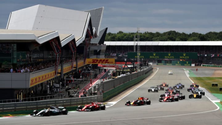 NORTHAMPTON, ENGLAND - JULY 16: Lewis Hamilton of Great Britain driving the (44) Mercedes AMG Petronas F1 Team Mercedes F1 WO8 leads Kimi Raikkonen of Finland driving the (7) Scuderia Ferrari SF70H, Max Verstappen of the Netherlands driving the (33) Red Bull Racing Red Bull-TAG Heuer RB13 TAG Heuer and the rest of the field round the first corner at the start during the Formula One Grand Prix of Great Britain at Silverstone on July 16, 2017 in Northampton, England. (Photo by Will Taylor-Medhurst/Getty Images)