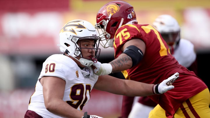 LOS ANGELES, CALIFORNIA – NOVEMBER 07: Jermayne Lole #90 of the Arizona State Sun Devils pushes off Alijah Vera-Tucker #75 of the USC Trojans during the second half of a game at Los Angeles Coliseum on November 07, 2020 in Los Angeles, California. (Photo by Sean M. Haffey/Getty Images)
