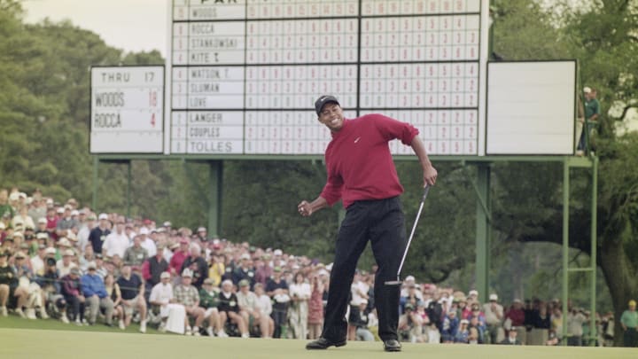 Tiger Woods of the United States celebrates after sinking a 4 feet putt to win the US Masters Golf Tournament with a record low score of 18 under par 13 April 1997 at the Augusta National Golf Club in Augusta, Georgia, United States. (Photo by Stephen Munday/Allsport/Getty Images)