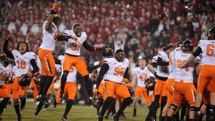 Dec 6, 2014; Norman, OK, USA; Oklahoma State Cowboys players celebrate a field goal against the Oklahoma Sooners in overtime. The Cowboys defeated the Sooners in overtime 38-35. at Gaylord Family – Oklahoma Memorial Stadium. Mandatory Credit: Mark D. Smith-USA TODAY Sports