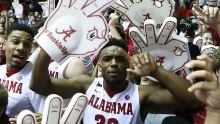 Feb 10, 2016; Tuscaloosa, AL, USA; Alabama Crimson Tide guard Retin Obasohan (32) celebrates with the fans after his team defeated the Aggies 63-62 at Coleman Coliseum. Mandatory Credit: Marvin Gentry-USA TODAY Sports