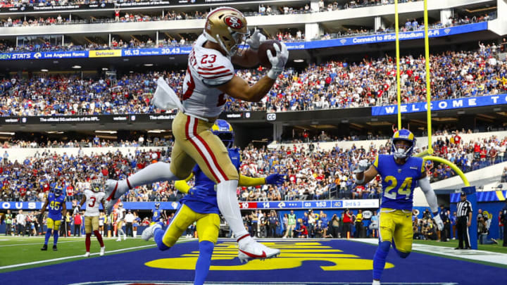 INGLEWOOD, CALIFORNIA - OCTOBER 30: Christian McCaffrey #23 of the San Francisco 49ers catches the ball for a touchdown as Jalen Ramsey #5 and Taylor Rapp #24 of the Los Angeles Rams defend during the third quarter at SoFi Stadium on October 30, 2022 in Inglewood, California. (Photo by Ronald Martinez/Getty Images)