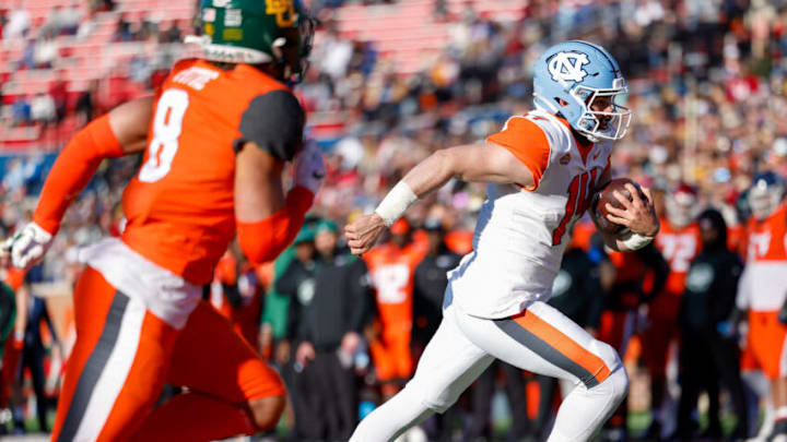 Feb 5, 2022; Mobile, AL, USA; American squad quarterback Sam Howell of North Carolina (14) scores a touchdown in the second half against the National squad at Hancock Whitney Stadium. Mandatory Credit: Nathan Ray Seebeck-USA TODAY Sports