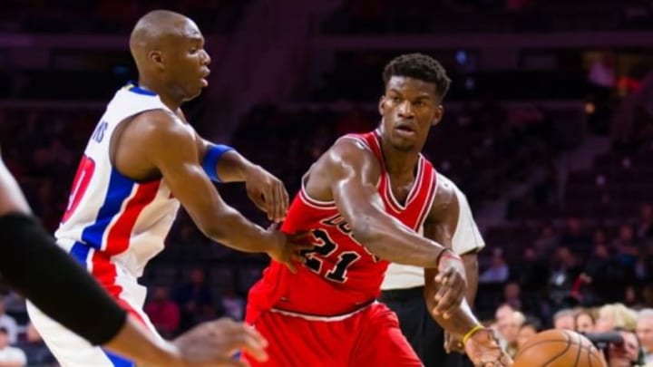 Oct 7, 2014; Auburn Hills, MI, USA; Chicago Bulls guard Jimmy Butler (21) passes the ball on Detroit Pistons guard Jodie Meeks (20) at The Palace of Auburn Hills. Mandatory Credit: Rick Osentoski-USA TODAY Sports