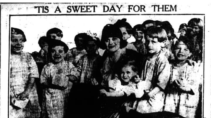 Actress Theda Bara giving candy to orphans in 1921.