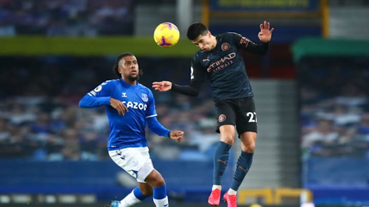 LIVERPOOL, ENGLAND - FEBRUARY 17: Alex Iwobi of Everton and Joao Cancelo of Manchester City during the Premier League match between Everton and Manchester City at Goodison Park on February 17, 2021 in Liverpool, United Kingdom. Sporting stadiums around the UK remain under strict restrictions due to the Coronavirus Pandemic as Government social distancing laws prohibit fans inside venues resulting in games being played behind closed doors. (Photo by Robbie Jay Barratt - AMA/Getty Images)