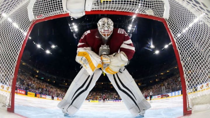 Latvia's goalkeeper Elvis Merzlikins stands in goal during the IIHF Men's World Championship Ice Hockey match between Germany and Latvia in Cologne, western Germany, on May 16, 2017. / AFP PHOTO / POOL / Wolfgang RATTAY (Photo credit should read WOLFGANG RATTAY/AFP/Getty Images)