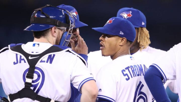 Marcus Stroman #6 of the Toronto Blue Jays is visited on the mound by pitching coach Pete Walker #40 as Danny Jansen #9 listens in the fourth inning during MLB game action against the Minnesota Twins. (Photo by Tom Szczerbowski/Getty Images)