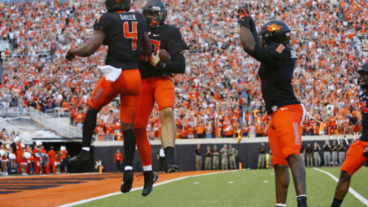 STILLWATER, OK - SEPTEMBER 28: Defensive end Brock Martin #40 of the Oklahoma State Cowboys celebrates his fumble recovery with cornerback A.J. Green #4 and linebacker Amen Ogbongbemiga #11 against the Kansas State Cowboys in the first quarter on September 28, 2019 at Boone Pickens Stadium in Stillwater, Oklahoma. (Photo by Brian Bahr/Getty Images)