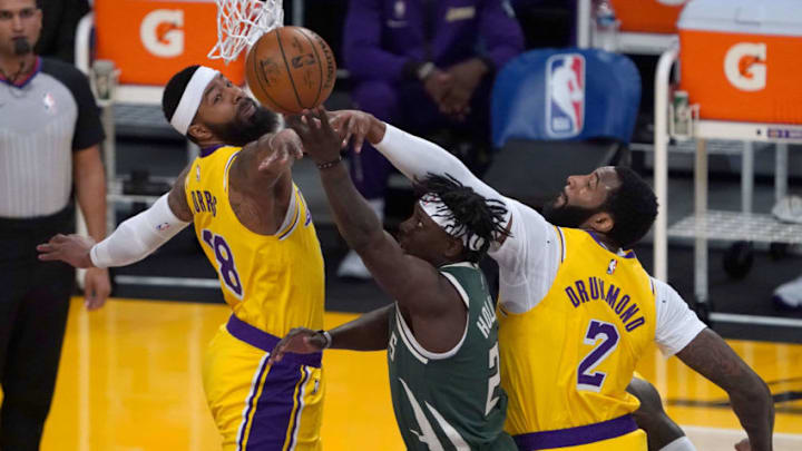 Mar 31, 2021; Los Angeles, California, USA; Milwaukee Bucks guard Jrue Holiday (21) is defended by Los Angeles Lakers forward Markieff Morris (88) and center Andre Drummond (2) during the first half at Staples Center. Mandatory Credit: Kirby Lee-USA TODAY Sports Mar 31, 2021; Los Angeles, California, USA; Milwaukee Bucks guard Jrue Holiday (21) is defended by Los Angeles Lakers forward Markieff Morris (88) and center Andre Drummond (2) during the first half at Staples Center. Mandatory Credit: Kirby Lee-USA TODAY Sports