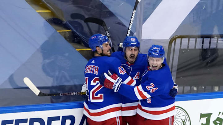 Chris Kreider #20 of the New York Rangers celebrates with his teammates after scoring a goal on James Reimer #47 of the Carolina Hurricanes during the second period in Game Three of the Eastern Conference Qualification Round. (Photo by Andre Ringuette/Freestyle Photo/Getty Images)