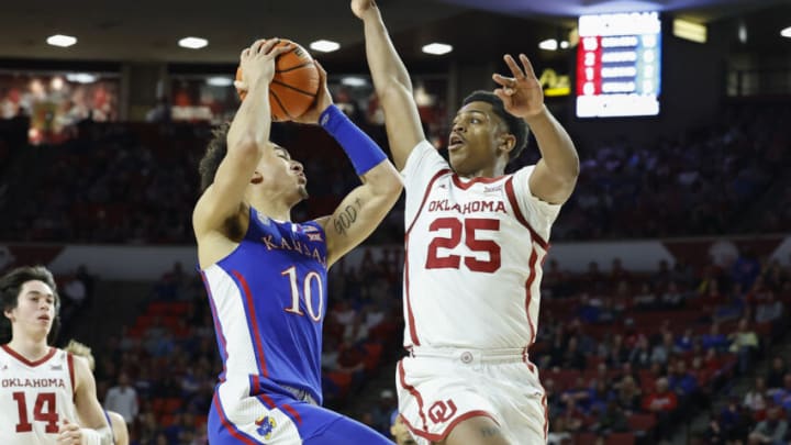 Feb 11, 2023; Norman, Oklahoma, USA; Kansas Jayhawks forward Jalen Wilson (10) drives against Oklahoma Sooners guard Grant Sherfield (25) during the first half at Lloyd Noble Center. Mandatory Credit: Alonzo Adams-USA TODAY Sports