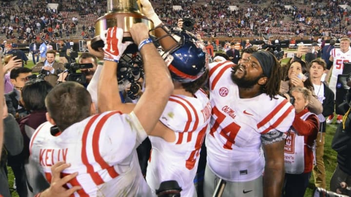 Nov 28, 2015; Starkville, MS, USA; Mississippi Rebels players celebrate with the Egg Bowl trophy after the game against the Mississippi State Bulldogs at Davis Wade Stadium. Mississippi won 38-27. Mandatory Credit: Matt Bush-USA TODAY Sports
