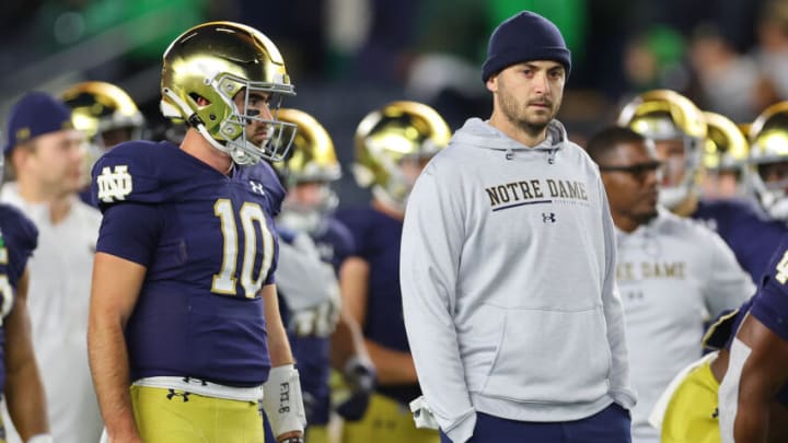 SOUTH BEND, INDIANA - NOVEMBER 05: Drew Pyne #10 and offensive coordinator Tommy Rees of the Notre Dame Fighting Irish look on prior to the game against the Clemson Tigers at Notre Dame Stadium on November 05, 2022 in South Bend, Indiana. (Photo by Michael Reaves/Getty Images)