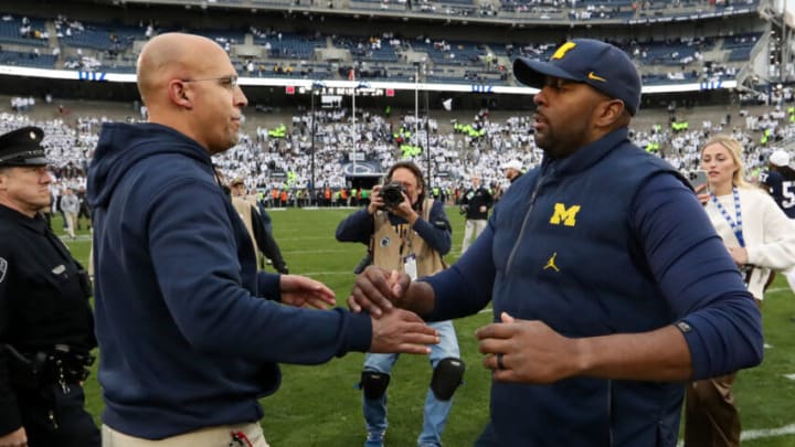 Nov 11, 2023; University Park, Pennsylvania, USA; Penn State Nittany Lions head coach James Franklin (left) shakes hands with Michigan Wolverines offensive line coach Sherrone Moore (right) following a game at Beaver Stadium. Michigan won 24-15. Mandatory Credit: Matthew O'Haren-USA TODAY Sports