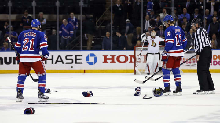 May 4, 2017; New York, NY, USA; New York Rangers center Derek Stepan (21) and New York Rangers defenseman Marc Staal (18) pick up gloves and sticks after a fight with the Ottawa Senators during the third period in game four of the second round of the 2017 Stanley Cup Playoffs at Madison Square Garden. Mandatory Credit: Adam Hunger-USA TODAY Sports