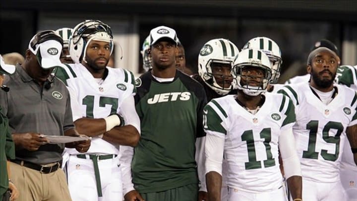 Aug 17, 2013; East Rutherford, NJ, USA; New York Jets quarterback Geno Smith (middle) watches from the sideline during the game against the Jacksonville Jaguars at MetLife Stadium. Mandatory Credit: John O